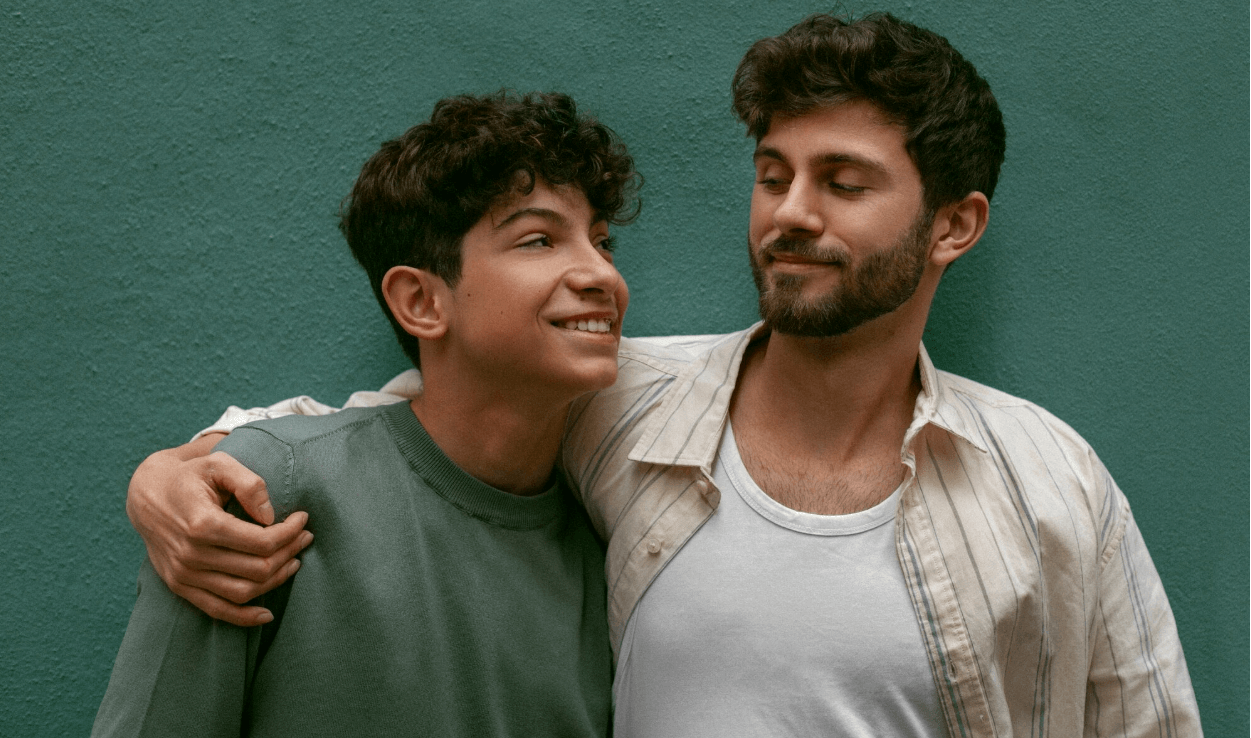 Indian gay couple silhouette with city skyline